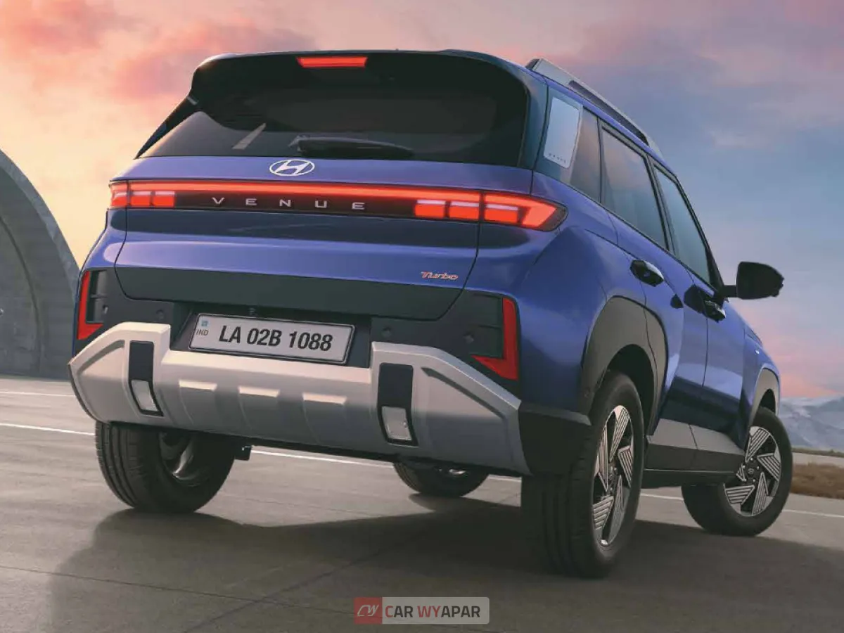 Rear profile of a 2025 Hyundai Venue featuring the new connected LED tail lamp design and a sporty rear spoiler.